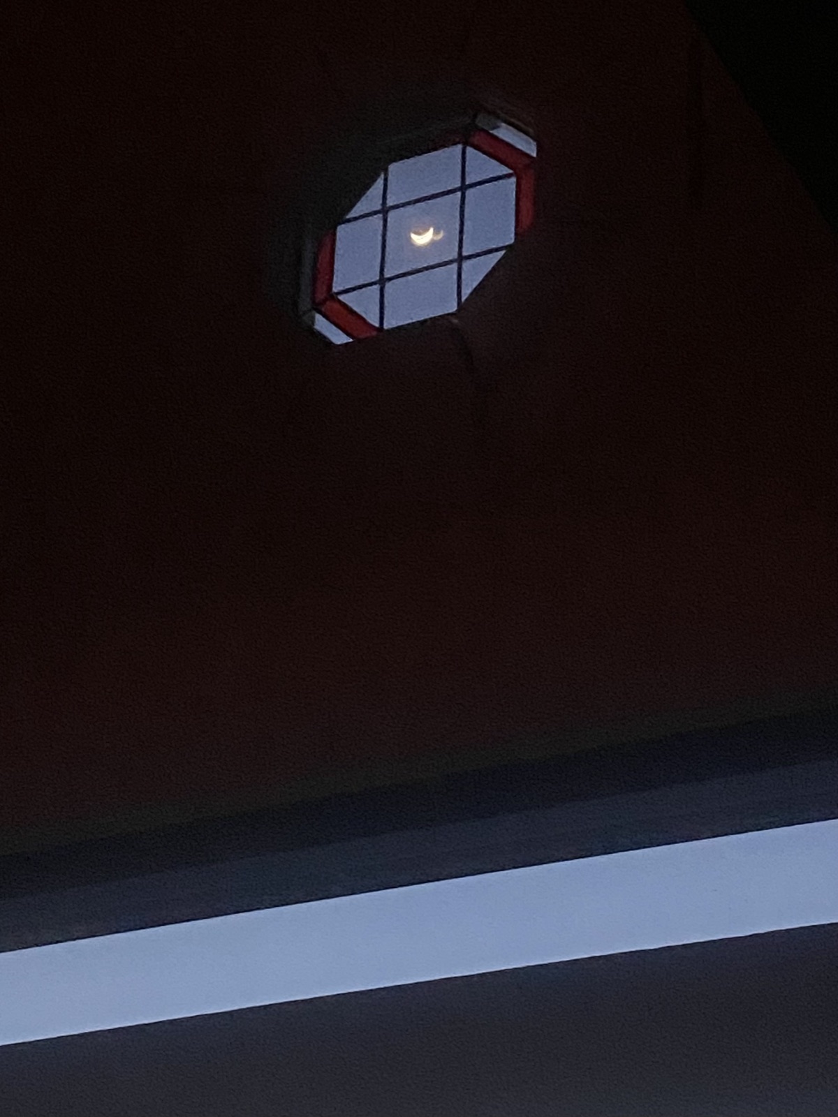 Crescent moon through a Panoramic House window